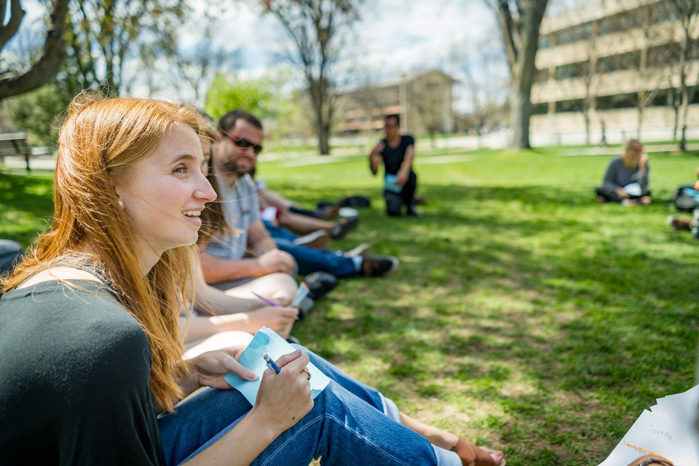 Student taking notes outside