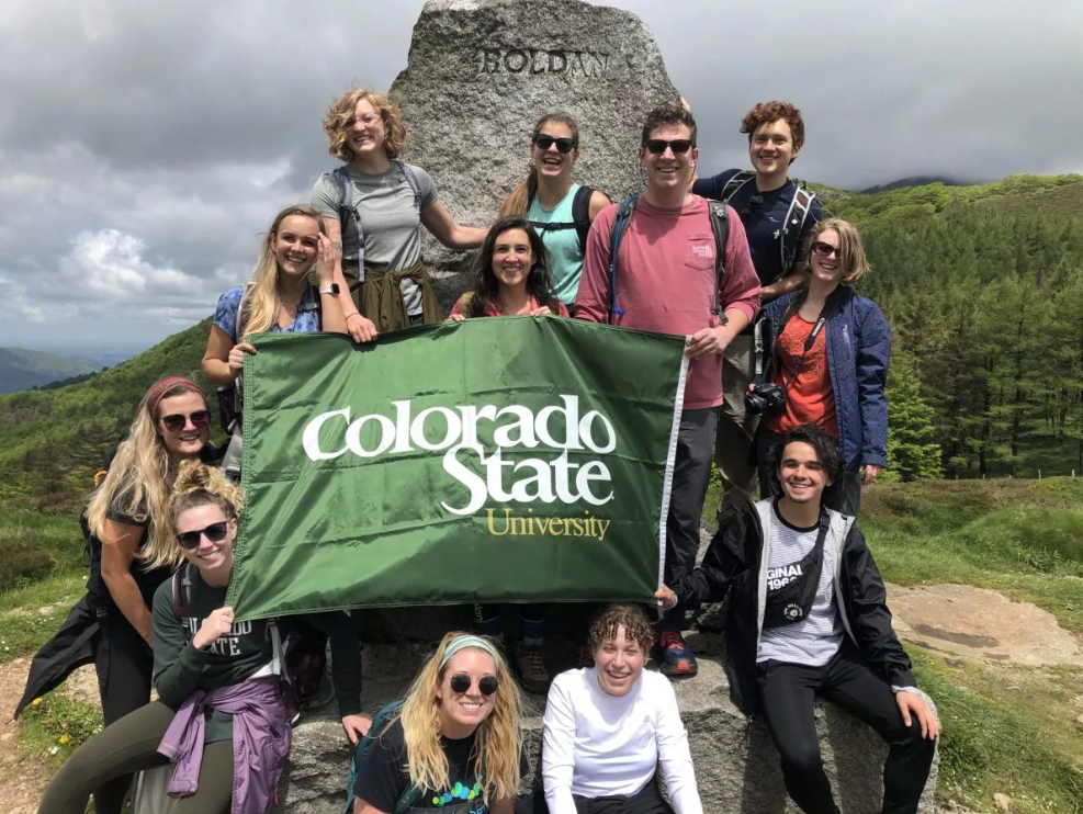 LLC students posing with a CSU flag during the Camino Abroad program